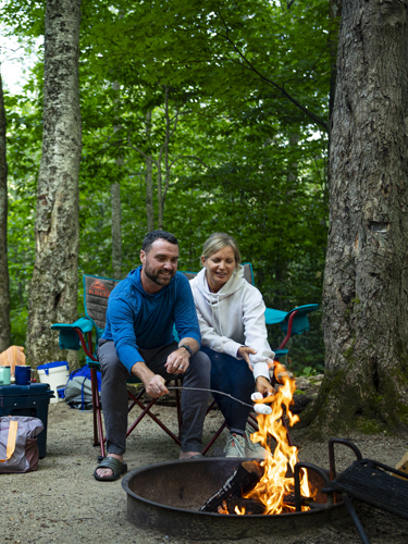 camper reading at campfire at lafayette place campground