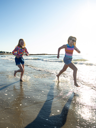 two girls running on north beach hampton