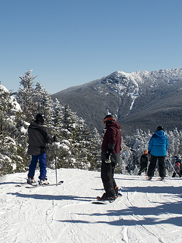 skiers on intermediate trail at cannon mountain