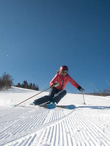 woman skier on corduroy snow at cannon