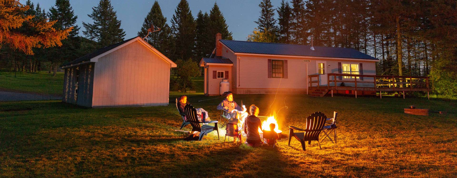 family around at campfire at coleman lodges