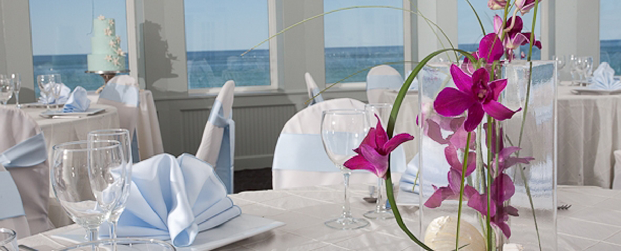 seashell event space wedding setup with orchid flowers