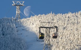 red and yellow tram in winter landscape with moon