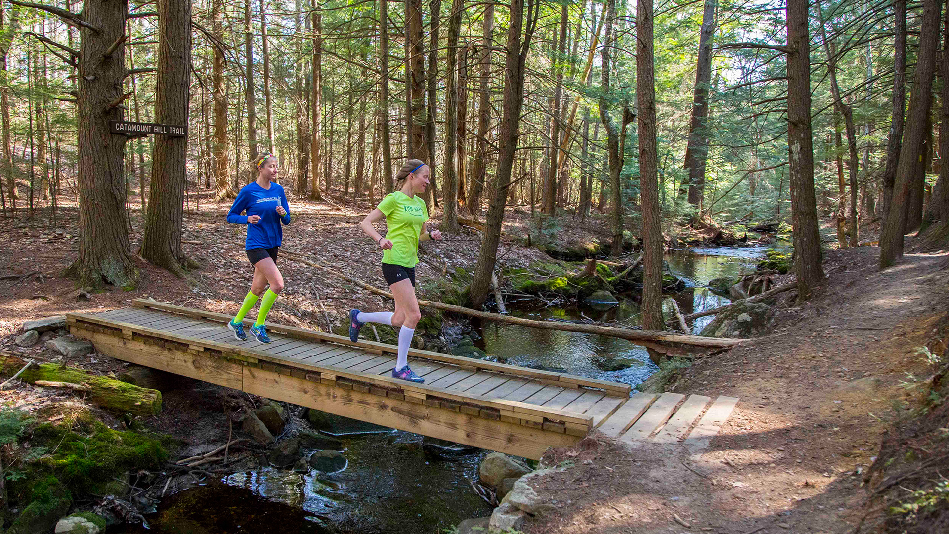 two people running down a trail